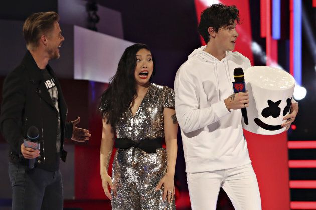 Awkwafina reacts to Shawn Mendes in a Marshmello costume onstage at the iHeartRadio MuchMusic Video Awards.