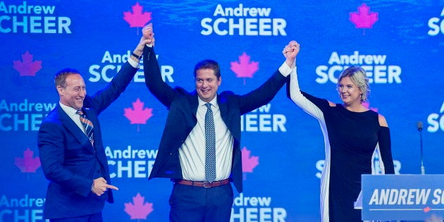 Conservative Leader Andrew Scheer, accompanied by his wife Jill, is introduced by former Conservative cabinet minister Peter MacKay, left, at the party's national policy convention in Halifax on Aug. 24, 2018.