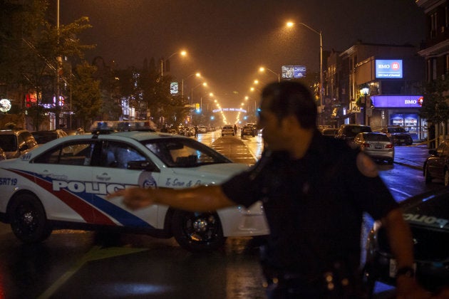 Toronto Police officers work on Danforth Street, where a shooting took place in Toronto, Ont.