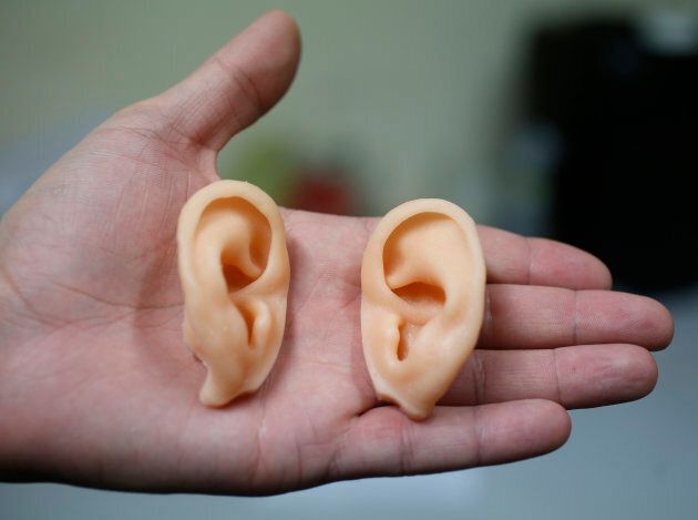 An employee at the Dreamdoll company displays a pair of ears at their workshop near Strasbourg on Dec. 2, 2014.