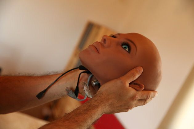 Catalan nanotechnology engineer Sergi Santos holds the head of Samantha, a sex doll packed with artificial intelligence, on March 31, 2017 in Barcelona.