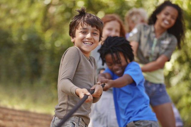 A group of kids in a tug-of-war game.