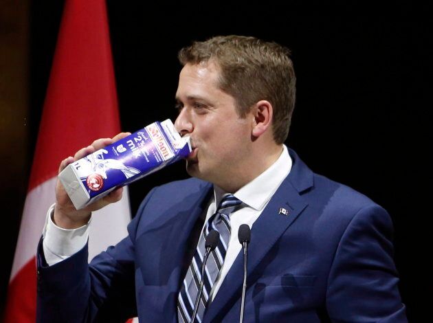 Conservative Leader Andrew Scheer drinks milk as he takes the stage at the National Press Gallery Dinner in Gatineau, Que. on June 3, 2017.