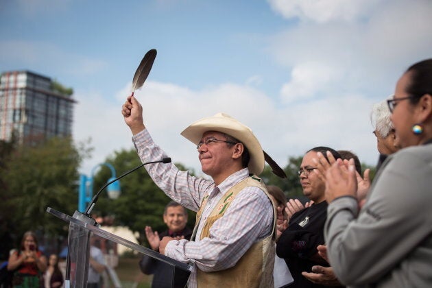 Coldwater Indian band Chief Lee Spahan raises an eagle feather after responding to a Federal Court of Appeal ruling on the Kinder Morgan Trans Mountain Pipeline expansion, during a news conference in Vancouver on Aug. 30, 2018.