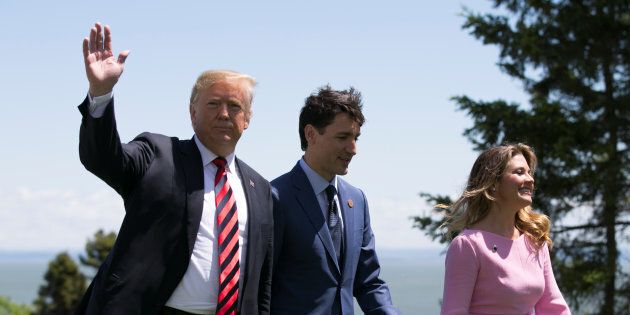 U.S. President Donald Trump walks with Prime Minister Justin Trudeau and wife Sophie Gregoire Trudeau during the G7 Summit in La Malbaie, Que. on June 8, 2018.