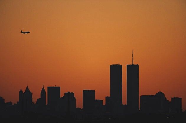 The sun sets at dusk over the Manhattan skyline silhouetting the Twin Towers of the World Trade Center.