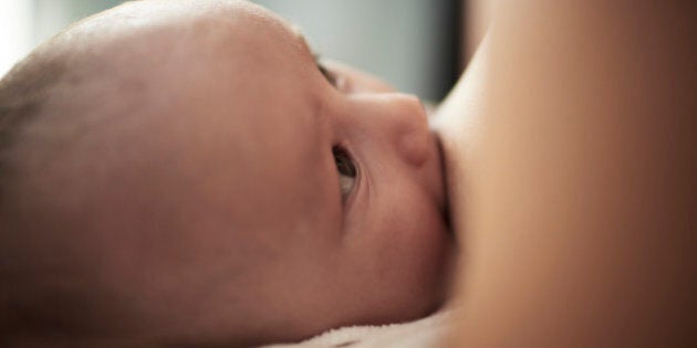 Baby breastfeeding from his mother