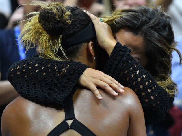 Naomi Osaka and her mother Tamaki Osaka embrace after Osaka's victory.