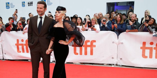 Bradley Cooper poses with Lady Gaga at the world premiere of