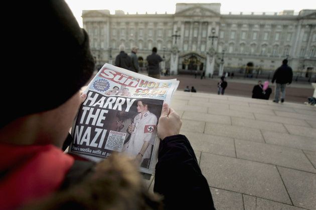 A man reads The Sun in front of Buckingham Palace on January 13, 2005 in London, England.