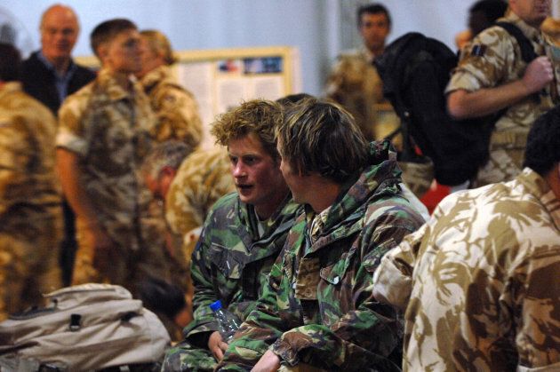 Prince Harry talks with another officer at Kandahar air field on February 29, 2008.