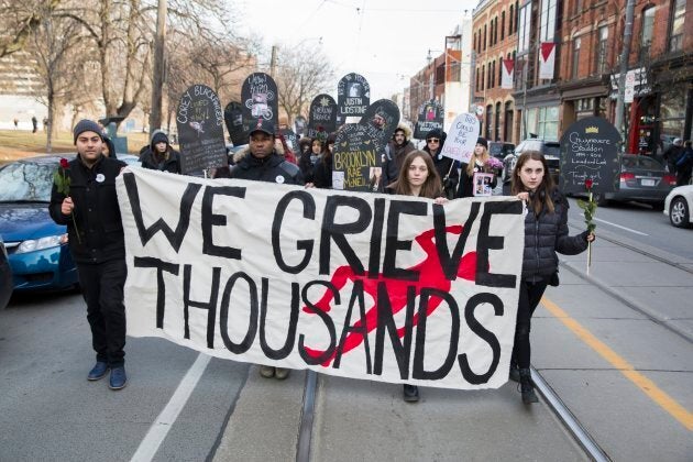 Protesters in Toronto walk to City Hall on Dec. 11, 2017, to call on Major John Tory to acknowledge the overdose crisis and the importance of safe injection sites like the one set up in Moss Park.