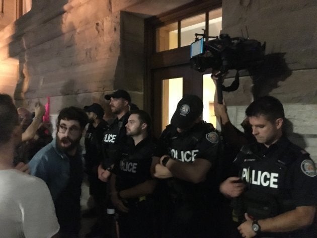 Police stand outside Toronto's Queen Park as protesters chanted on Sept. 17, 2018.