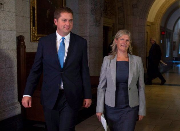 Conservative Leader Andrew Scheer walks with Leona Alleslev, who crossed the floor from the Liberals to Tories on Parliament Hill on Sept. 17, 2018.