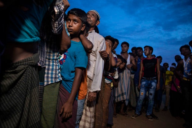 Rohingya wait in line for humanitarian aid in Kutupalong camp Aug. 27, 2018 in Kutupalong, Cox's Bazar, Bangladesh.