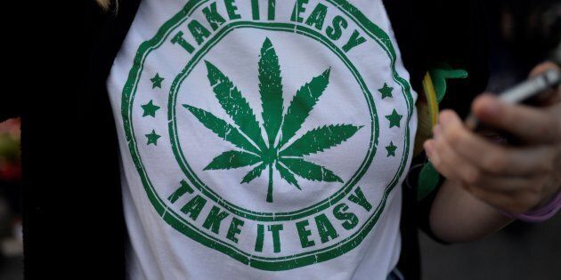 A woman wears a t-shirt featuring a cannabis leaf at the marijuana march in Ipanema, Rio de Janeiro, Brazil, May 6, 2017. On October 17, Quebecers will be able to light a joint legally — but it appears they will lose the right to buy T-shirts or posters with the marijuana leaf on them.