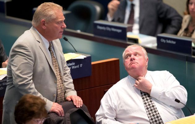 Premier Doug Ford speaks with his late brother, former Toronto mayor Rob Ford, in 2014.
