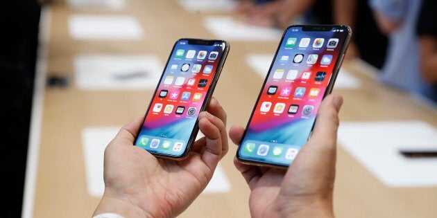 A man holds the newly released Apple iPhone XS and XS Max during a product demonstration following the Apple launch event at the Steve Jobs Theater in Cupertino, California on Sept. 12, 2018.