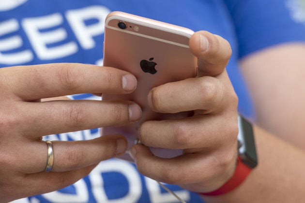 A shopper views an iPhone SE in 2016.