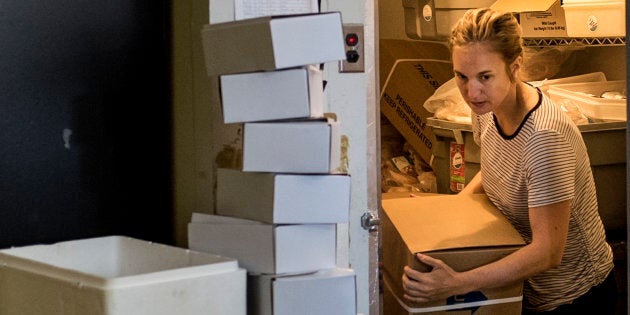 Hana Nelson moves a shipment of sockeye salmon from a commercial freezer at Afishionado Fishmongers in Halifax on, July 12, 2018.