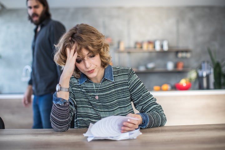 Man and woman, married couple having financial problems at home.