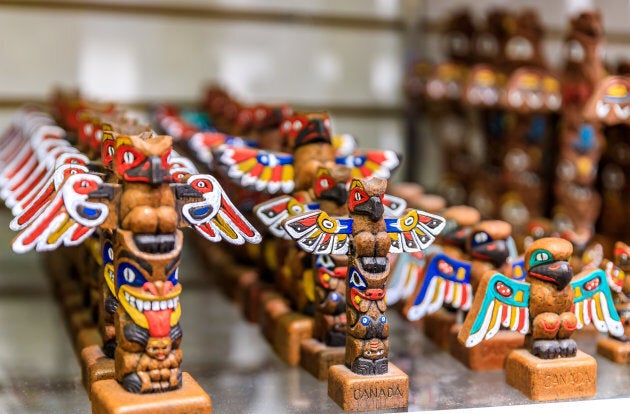 Carved totem pole souvenirs at a tourist shop in Vancouver Canada. Indigenous artist Jay Soule says most of the merchandise sold in souvenir shops is fake.