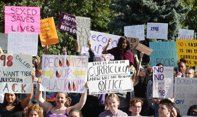 Over 100 students stage a sit-in on the lawn at Queen's Park in Toronto to follow up the #WeTheStudentsDoNotConsent walkout, Sept. 23, 2018.