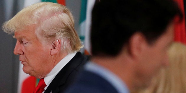 U.S. President Donald Trump passes Prime Minister Justin Trudeau during a working lunch for world leaders at the United Nations General Assembly in New York on Sept. 25, 2018.