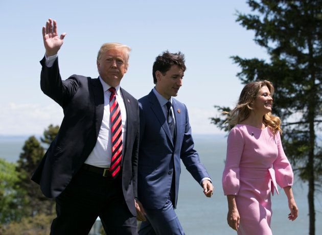 U.S. President Donald Trump walks with Prime Minister Justin Trudeau and his wife Sophie Gregoire Trudeau following at the G7 Summit in the Charlevoix town of La Malbaie, Que. on June 8, 2018.