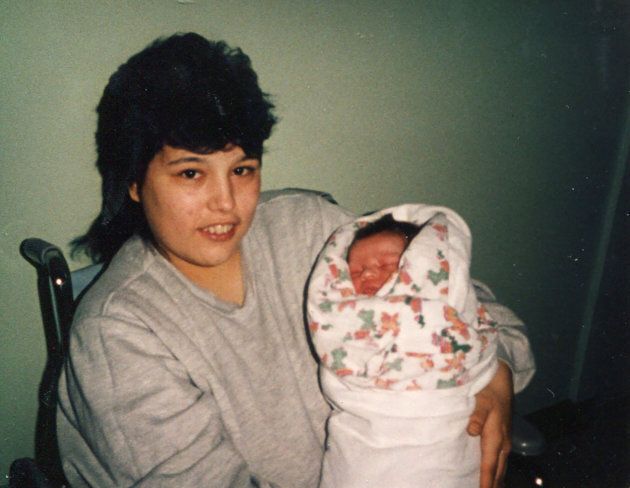 A photo provided by the family of Deidre Michelin shows her at age 18, holding her daughter Heidi.