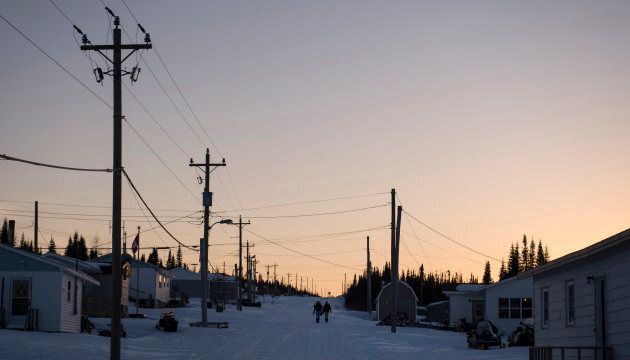 Girls walk through one of the main roads in Rigolet as the sun sets on the remote village on Labrador northern coast on Thursday, March 22, 2018.