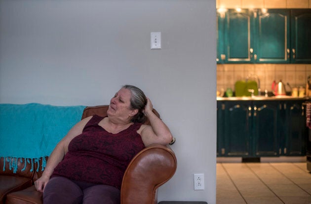 While sitting in her home, Charlotte Wolfrey cries remembering her daughter Deidre who was the victim of a murder/suicide 25 years ago in their isolated Inuit community of Rigolet, Labrador.