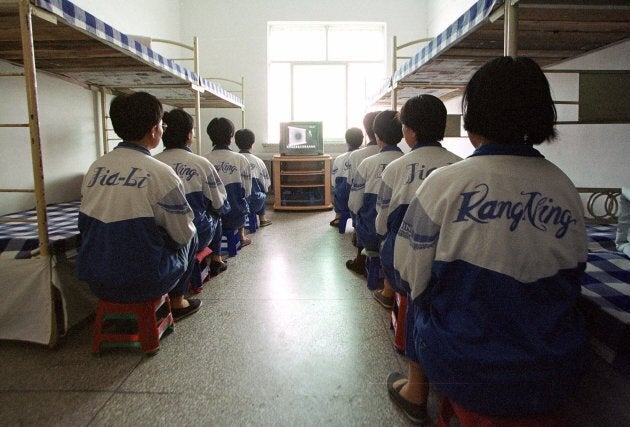 In this May 22, 2001 file photo, Falun Gong practitioners take part in deprogamming efforts enforced at the Masanjia reeducation-through-labour camp in northeast China's Liaoning province.