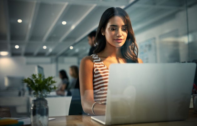 Shot of a businesswoman using a laptop during a late shift at work.