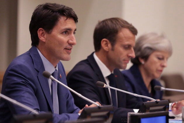 Prime Minister Justin Trudeau speaks alongside French President, Emmanuel Macron, center, and Britain's Prime Minister Theresa May during a Girl Education event at U.N. headquarters during the United Nations General Assembly on Sept. 25, 2018.