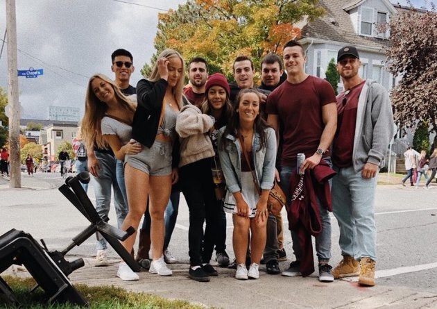 Allie Mousseau-Dempsey, front centre in jean jacket, and Andy Andretta, far right in grey sweater, were at the Panda Game with their friends Saturday when they ran into Mayor Jim Watson.