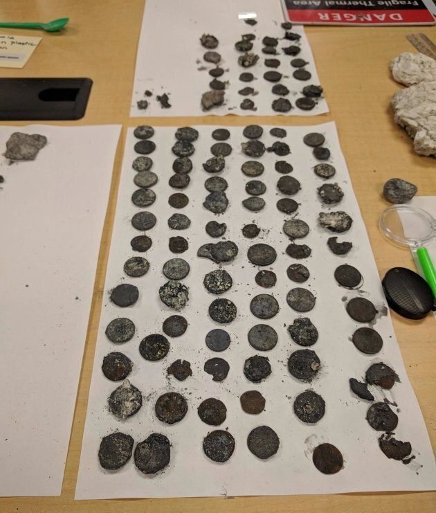 A closer look at some of the coins found near the geyser's vent.