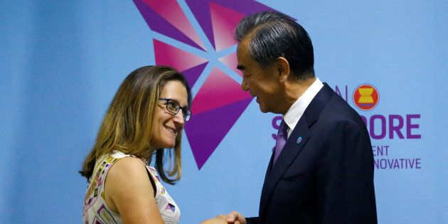 Foreign Minister Chrystia Freeland and China's foreign minister, Wang Yi, shake hands during a bilateral meeting on the sidelines of the ASEAN Foreign Ministers' Meeting in Singapore, Aug. 3, 2018.