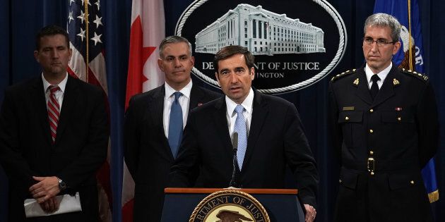 Assistant U.S. Attorney General for National Security John C. Demers speaks as U.S. Attorney for the Western District of Pennsylvania Scott W. Brady (2nd left), FBI Deputy Assistant Director Eric Welling (left), and RCMP Director General Mark Flynn (right) listen during a news conference to announce criminal charges Oct. 4, 2018 in Washington, D.C.