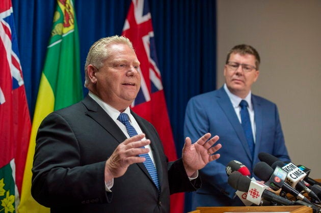 Ontario Premier Doug Ford speaks as Saskatchewan Premier Scott Moe listens during a media event in Saskatoon on Oct. 4, 2018.