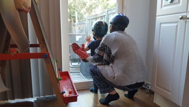 The author and her son playing a game of "oven mitts," which obviously requires helmets.