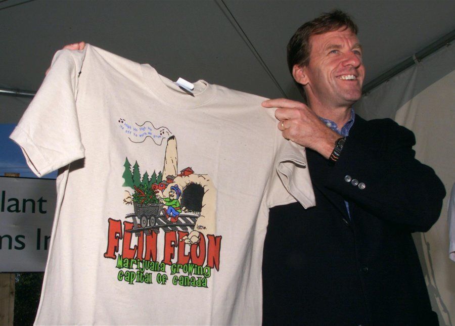 Former Health Minister Allan Rock, pictured here on Aug. 2, 2001, holds up a T-shirt proclaiming Flin Flon the marijuana growing capital of Canada after an inspection tour of an underground medicinal marijuana crop growing in the Trout Lake mine.