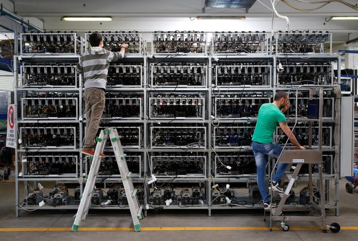 Employees work on Bitcoin mining computers at Bitminer Factory in Florence, Italy on April 6, 2018.