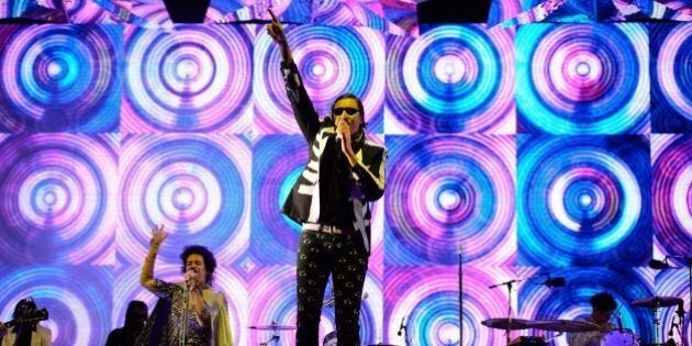 Canadian band Arcade Fire headlines the Pyramid Stage on the first official day of the Glastonbury Festival of Music and Performing Arts on Worthy Farm in Somerset, south west England, on June 27, 2014. AFP PHOTO / LEON NEAL (Photo credit should read LEON NEAL/AFP/Getty Images)