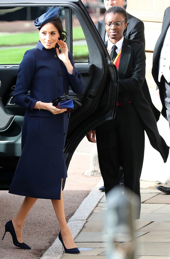 Meghan arrives to attend the wedding of Princess Eugenie of York to Jack Brooksbank at St George's Chapel, Windsor Castle, in Windsor last Friday. Check that navy coat!