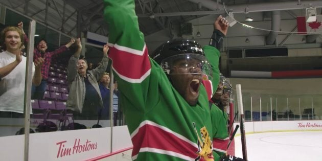 A member of the Kenya Ice Lions celebrates a teammate's goal during their first-ever proper hockey game against another team.