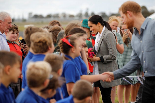 The Duke and Duchess of Sussex interact with children from Dubbo South Public School after arriving at Dubbo Airport on Wednesday.