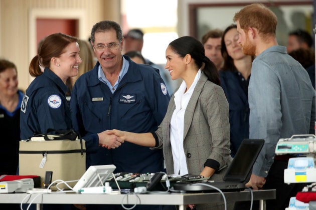 The Duke and Duchess of Sussex meet with health workers at the Royal Flying Doctors Service hangar on Wednesday.