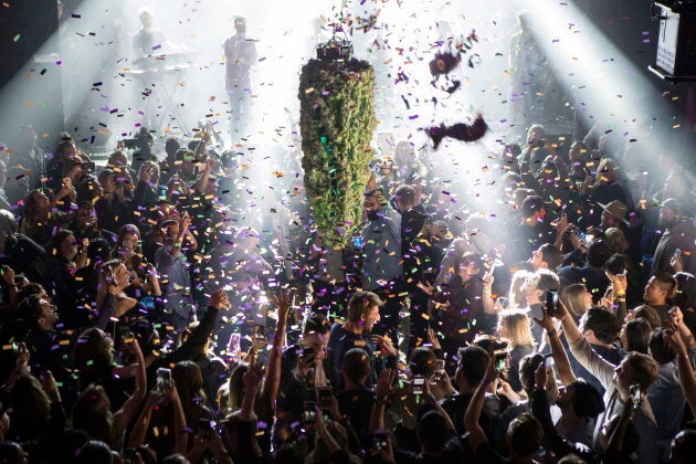 A depiction of a cannabis bud hangs from the ceiling as a band plays at Leafly's countdown party in Toronto, Tuesday, Oct. 16, 2018, as they prepare to mark the legalization of Cannabis across Canada. (Chris Young/The Canadian Press via AP)