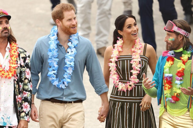 Meghan and Harry with some colourfully-clothed Australians.